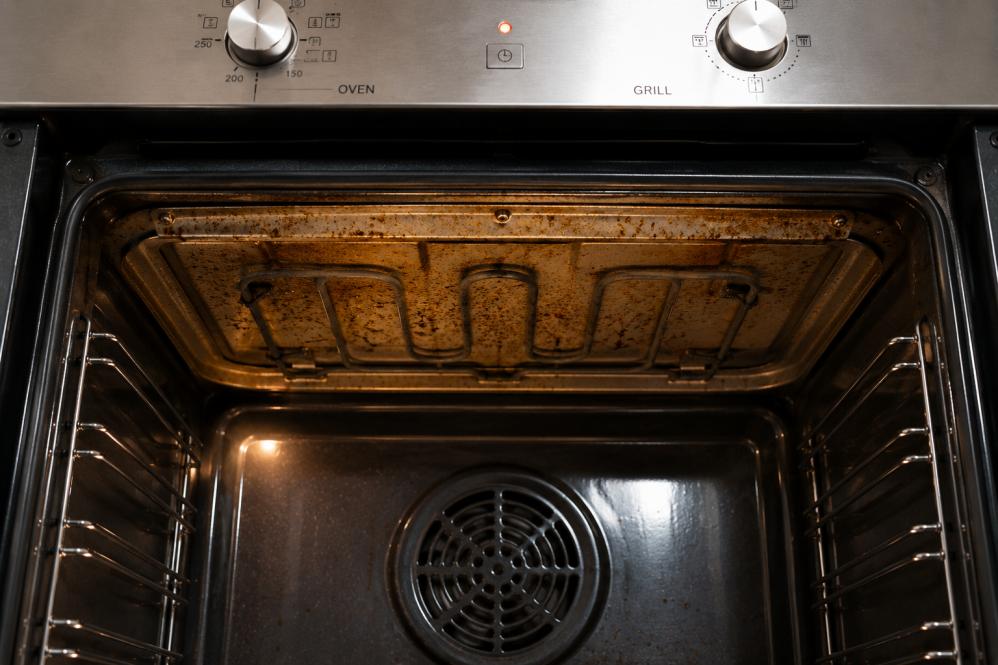 Grease build-up around the top grill section inside a modern oven