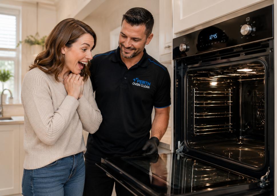 Happy customer admiring her freshly cleaned oven with a professional oven cleaner standing beside her.